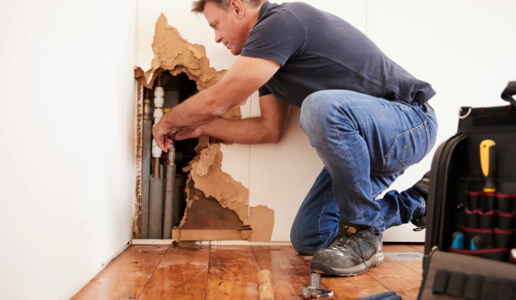 Plumber Fixing Burst Pipe