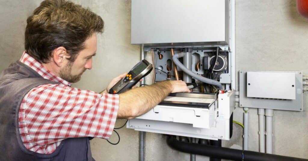 Plumber Repairing Boiler