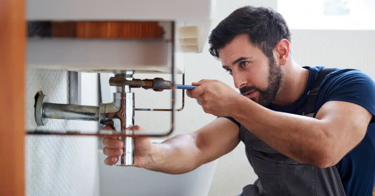 stop water leak - plumber attending to sink