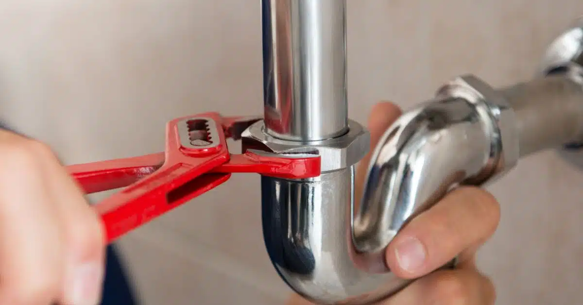 Stop Water Leak - Wrench tightening a pipe
