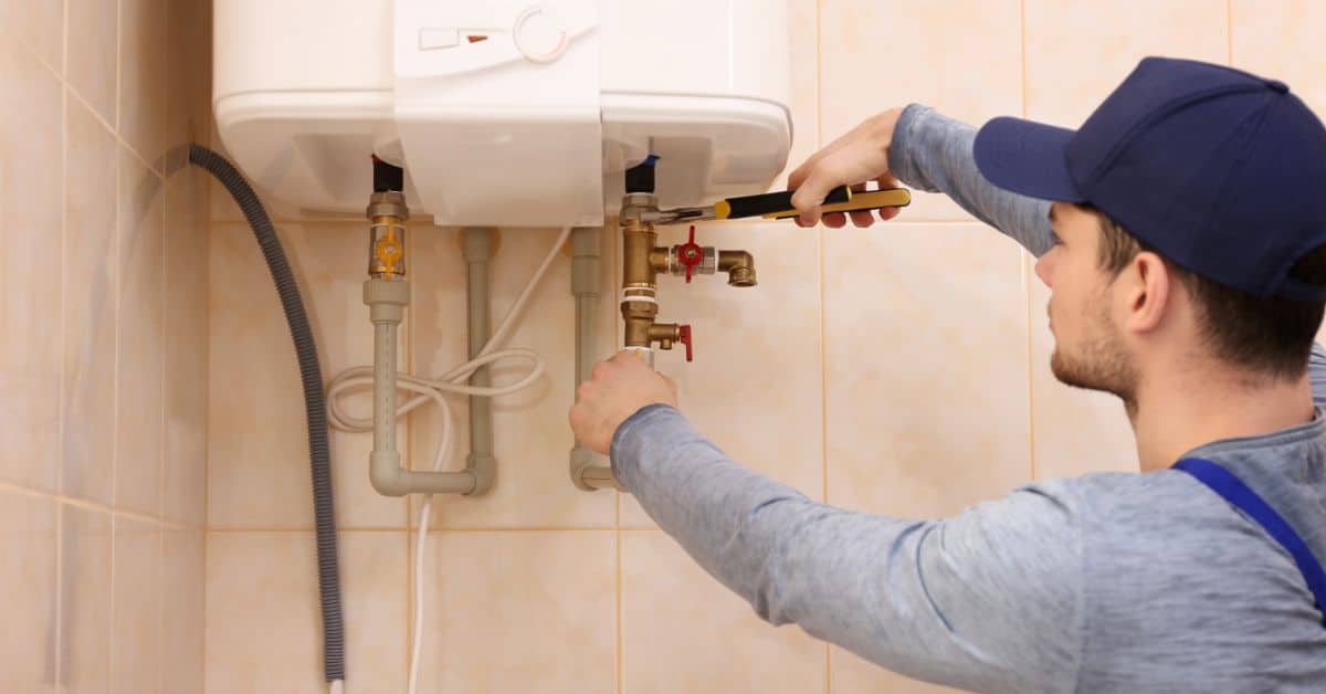 Plumber Tightening Boiler Connections