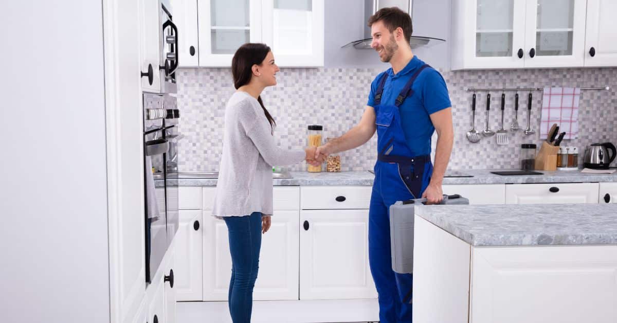 Happy Homeowner shaking plumbers hand