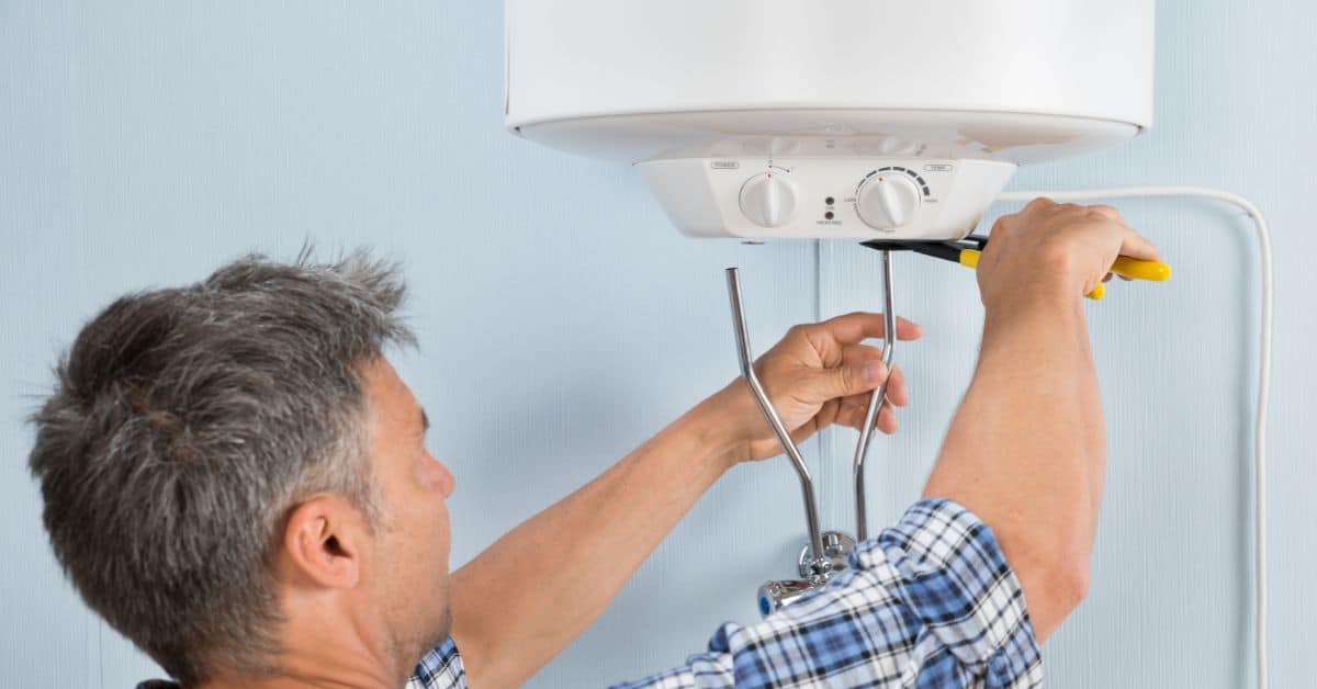 Plumber installing water heater