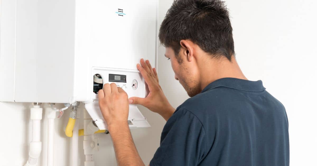 Technician resetting boiler