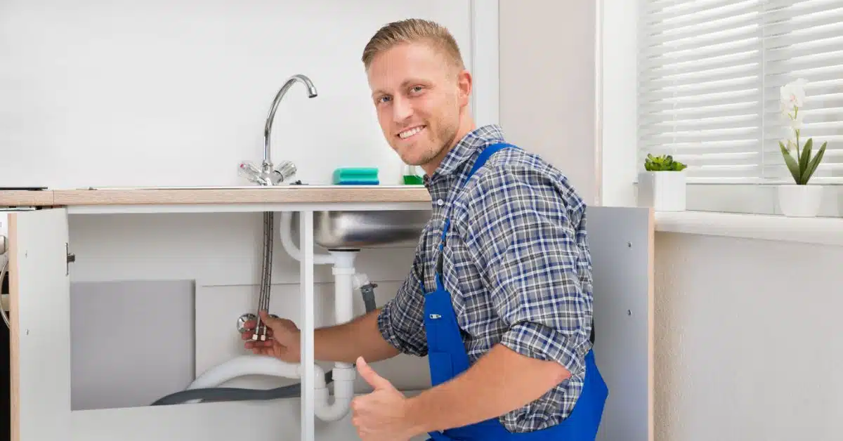 Happy Plumber dealing with kitchen sink