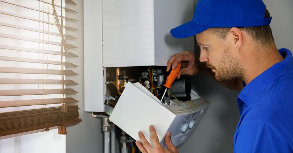 boiler maintenance near me - plumber working on boiler