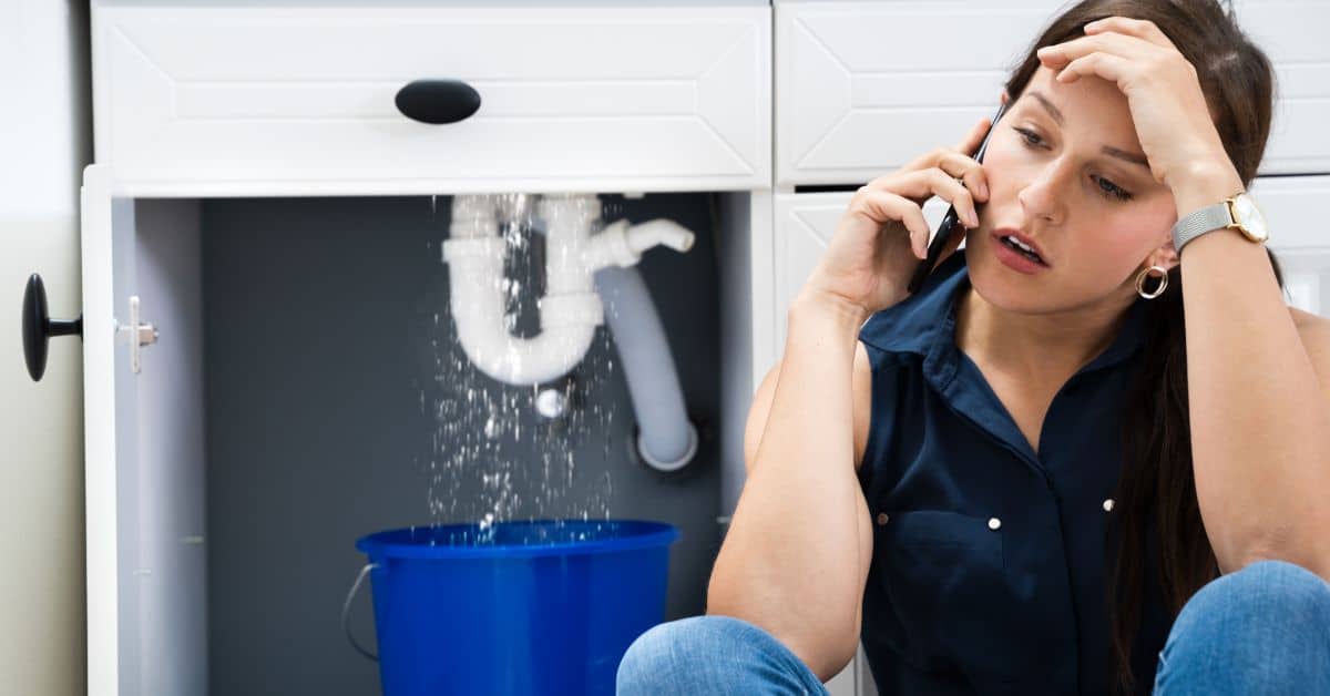 plumber near me - Lady calling a plumber due to emergency sink leak
