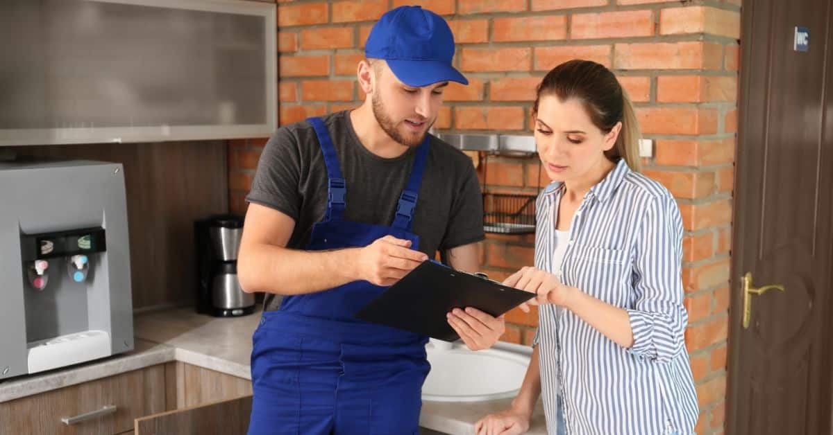 Plumber giving client a breakdown of the service they were given.
