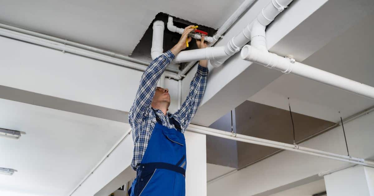 commercial plumbing - adjusting pipes in the roof