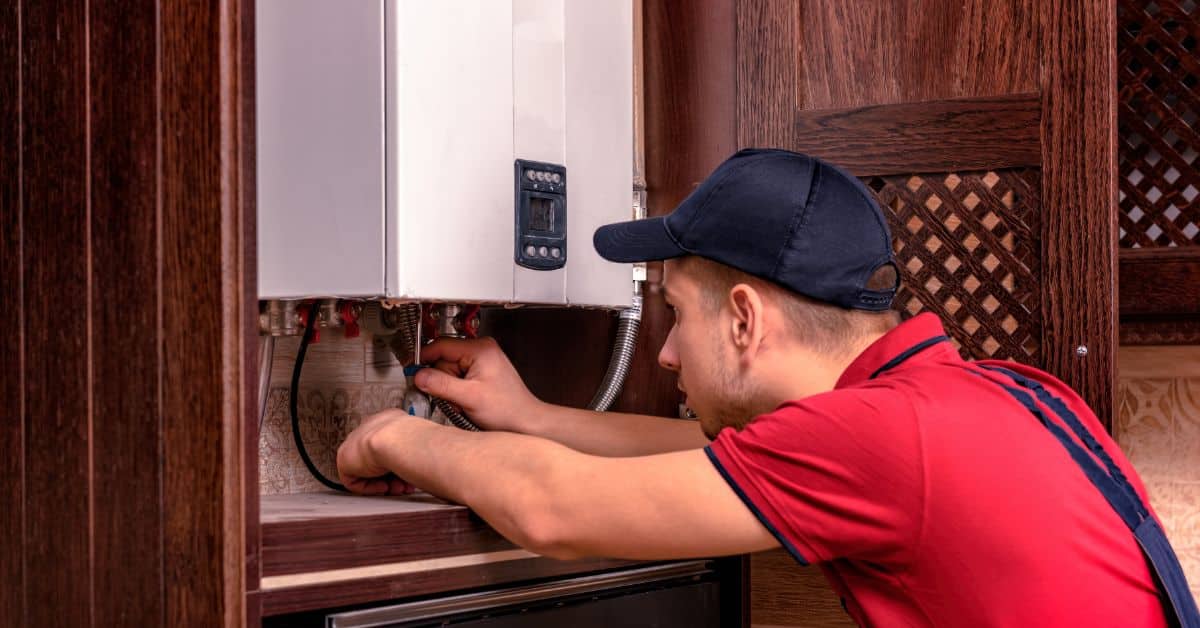 General plumber fixing a boiler unit