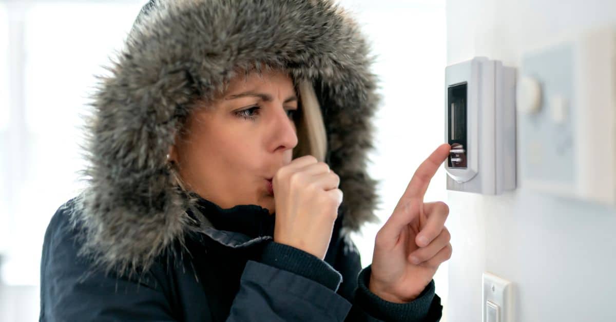 Cold lady with a thermostat