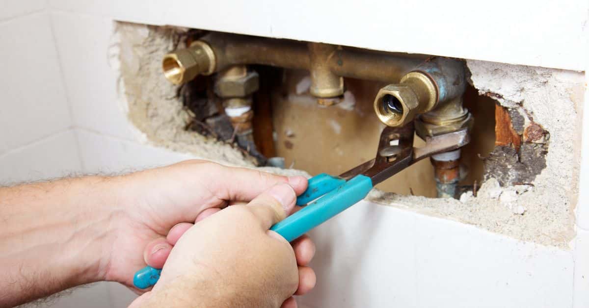 Fixing a leak in the wall due to damaged pipes