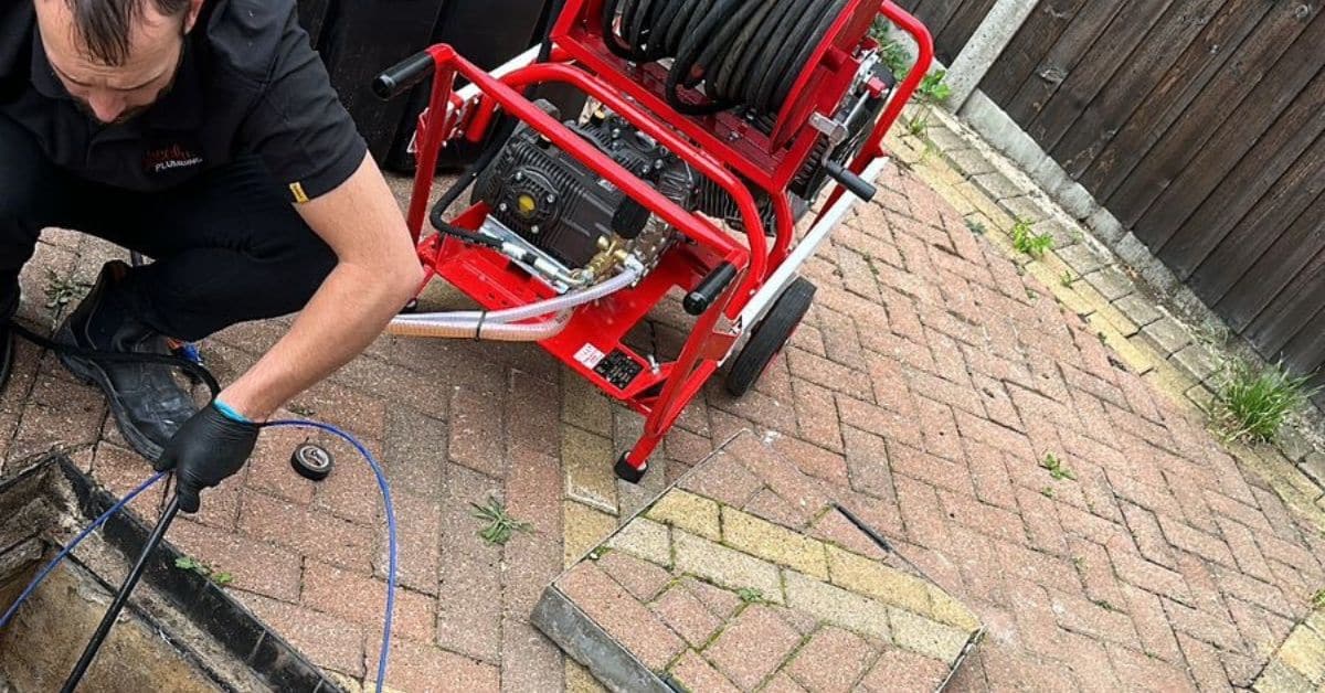 power flushing equipment - Absolute Plumbing Ltd Team using a power flush unit