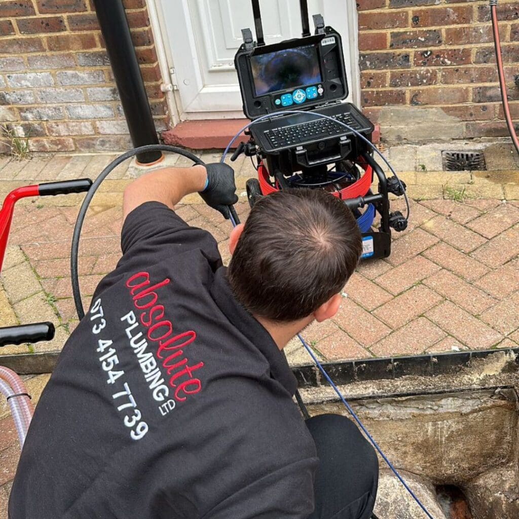 Absolute Plumbing Limited Team member doing a drain inspection