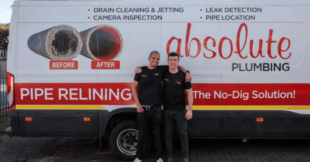 Absolute Plumbing Limited team members standing in front of one of the company vans