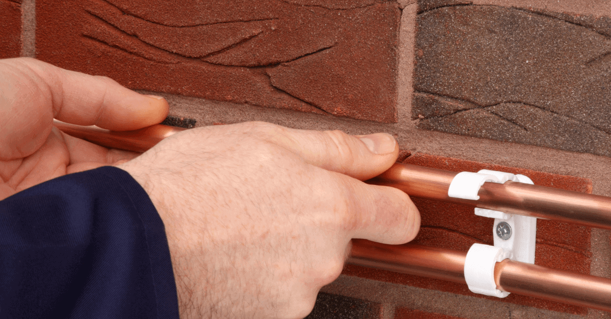 Checking and securing copper water pipes with pipe clips 