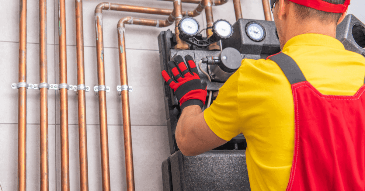 Professional plumber inspecting a domestic heating system 