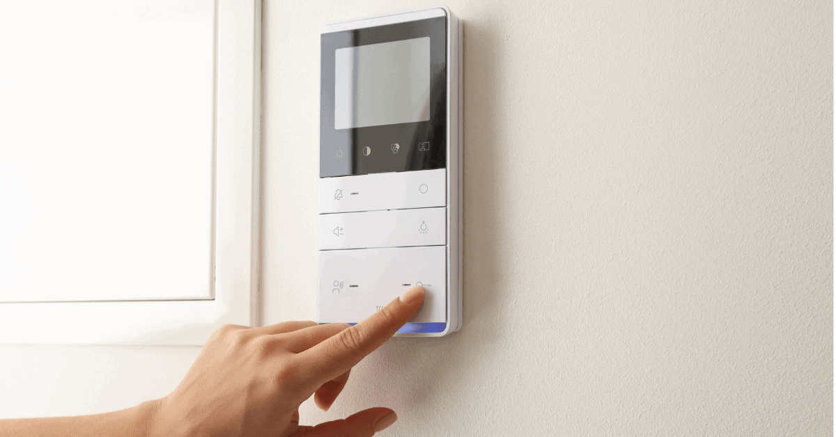 Person adjusting a home thermostat