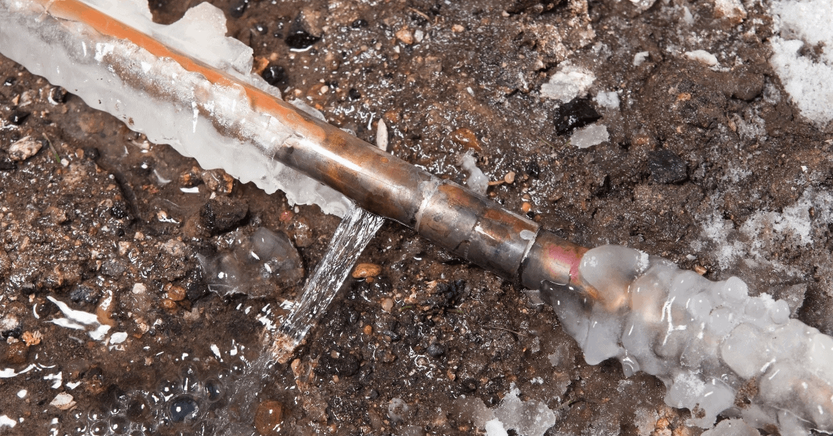 Frozen household water pipe covered in ice
