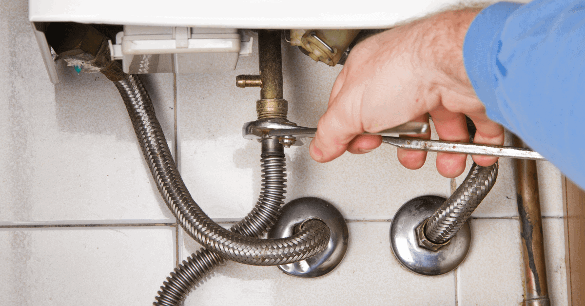 Plumber working on domestic water pipework 