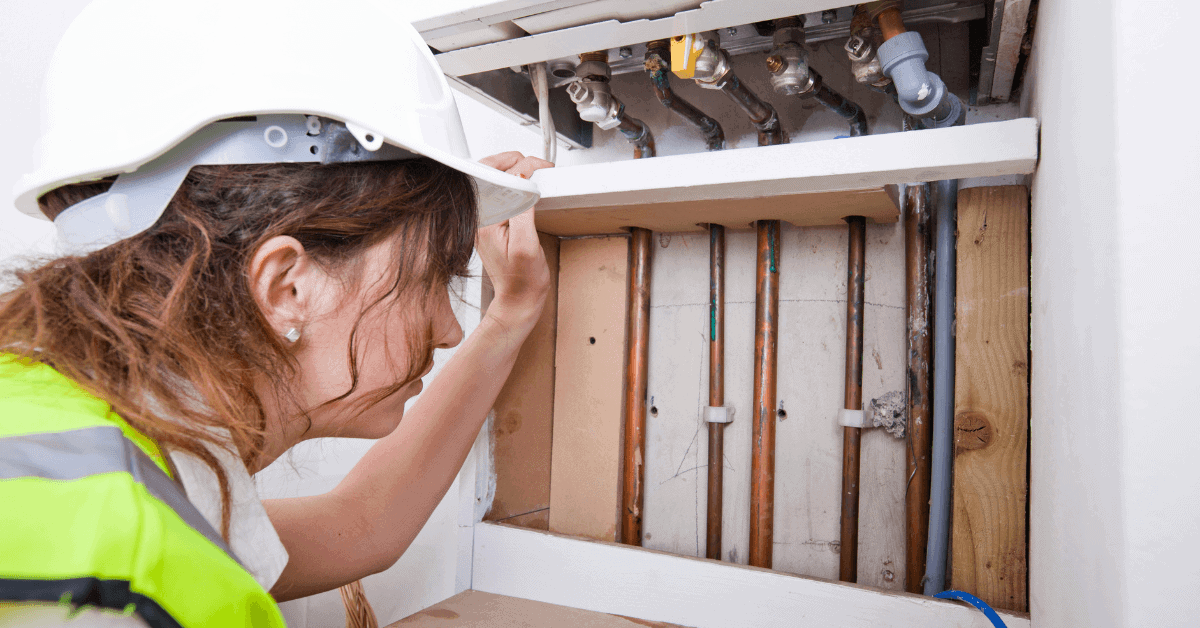 Heating engineer inspecting domestic pipework