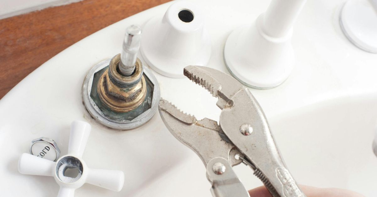 tightening kitchen taps with a monkey wrench