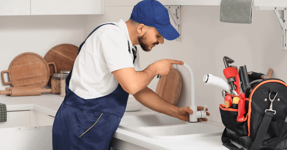 Plumber preparing to install a kitchen tap 